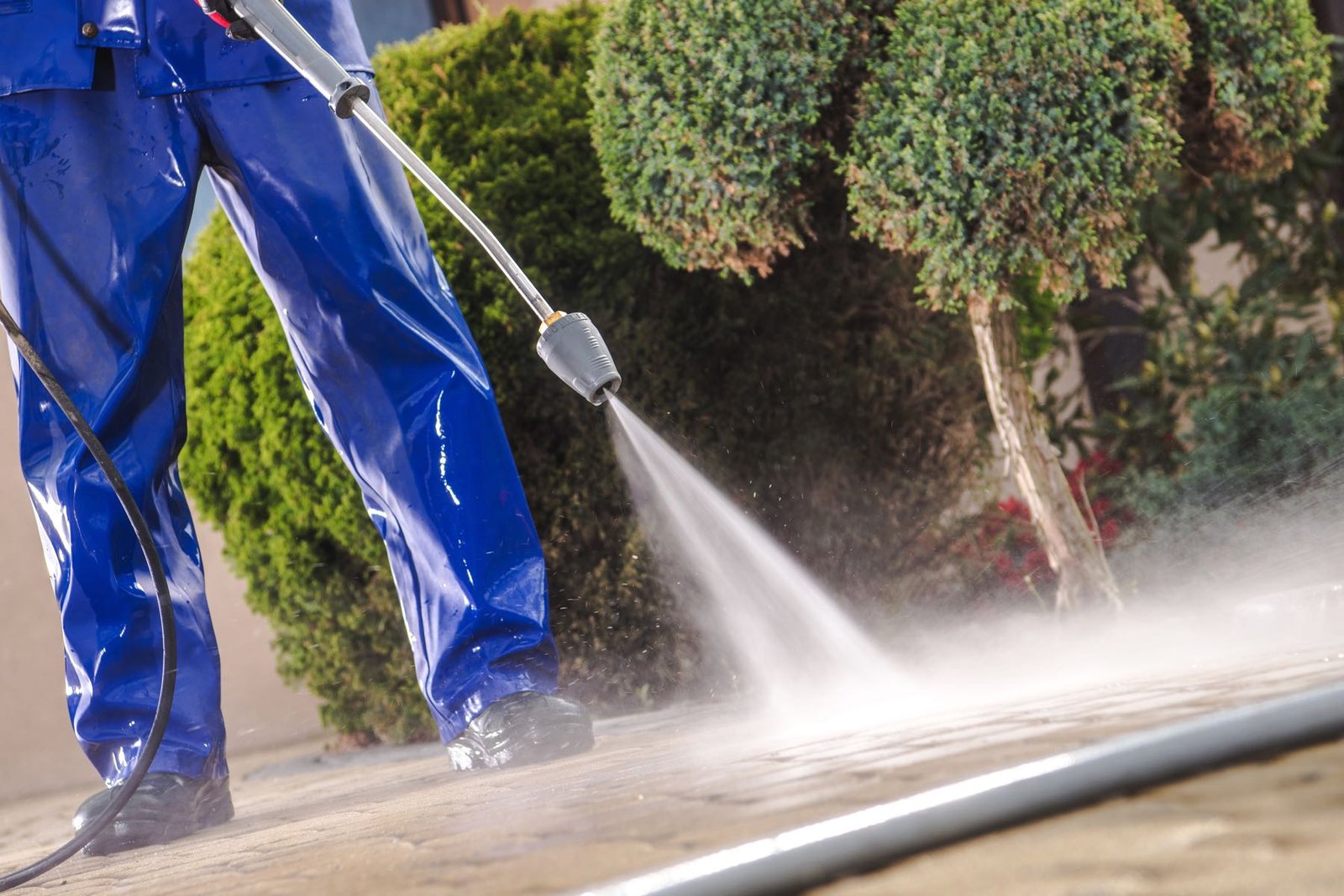 Men Washing Garden Residential Brick Paths With Professional Pressure Washer Men Washing Garden Residential Brick Paths with Professional Pressure Washer