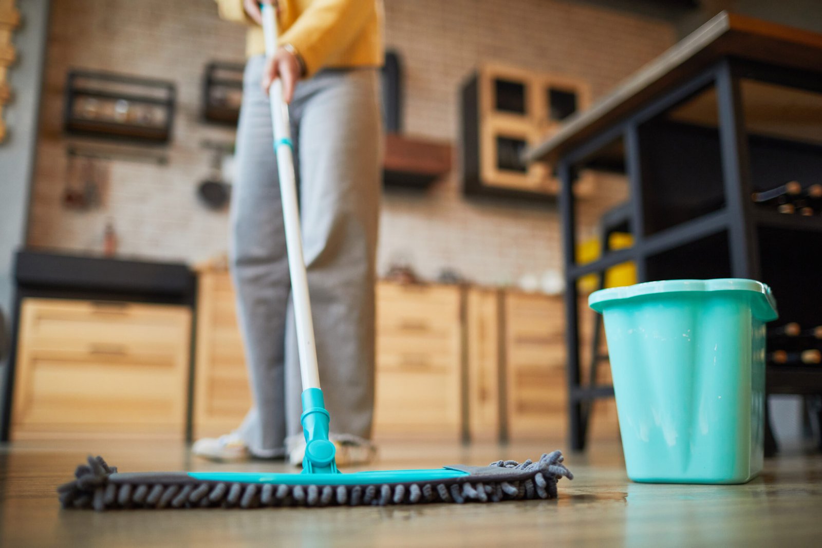 Woman Cleaning Floors at Home Close up background of unrecognizable woman mopping floors while cleaning cozy apartment, copy space
