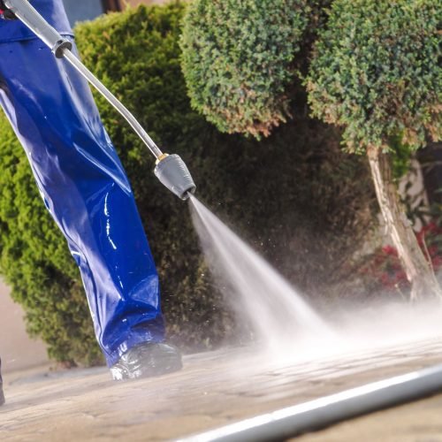 Men Washing Garden Residential Brick Paths With Professional Pressure Washer Men Washing Garden Residential Brick Paths with Professional Pressure Washer
